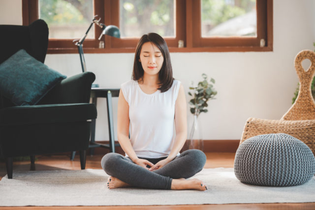 happy asian woman sporty attractive practicing meditation home scaled